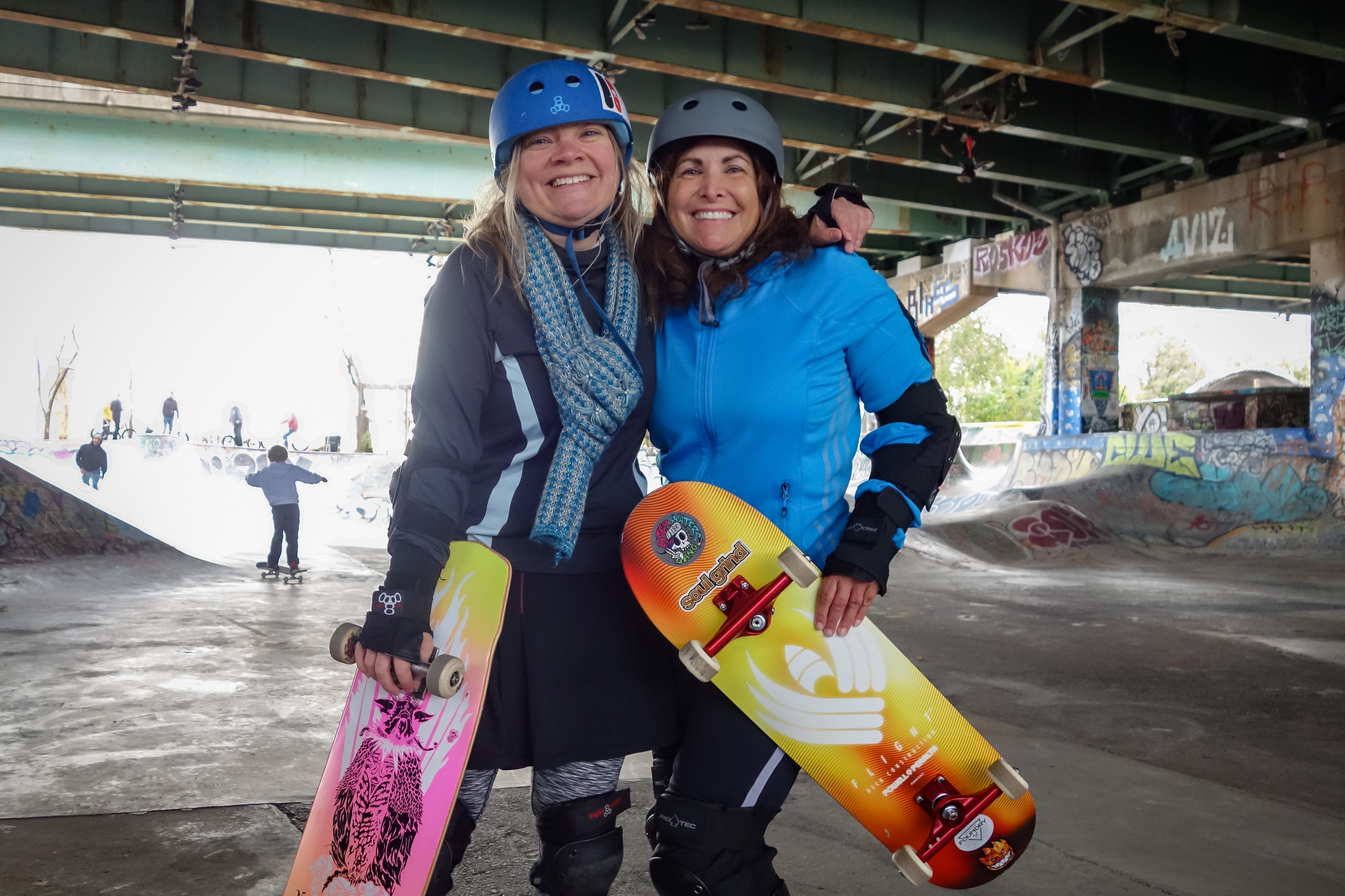 Two adult women skateboarders