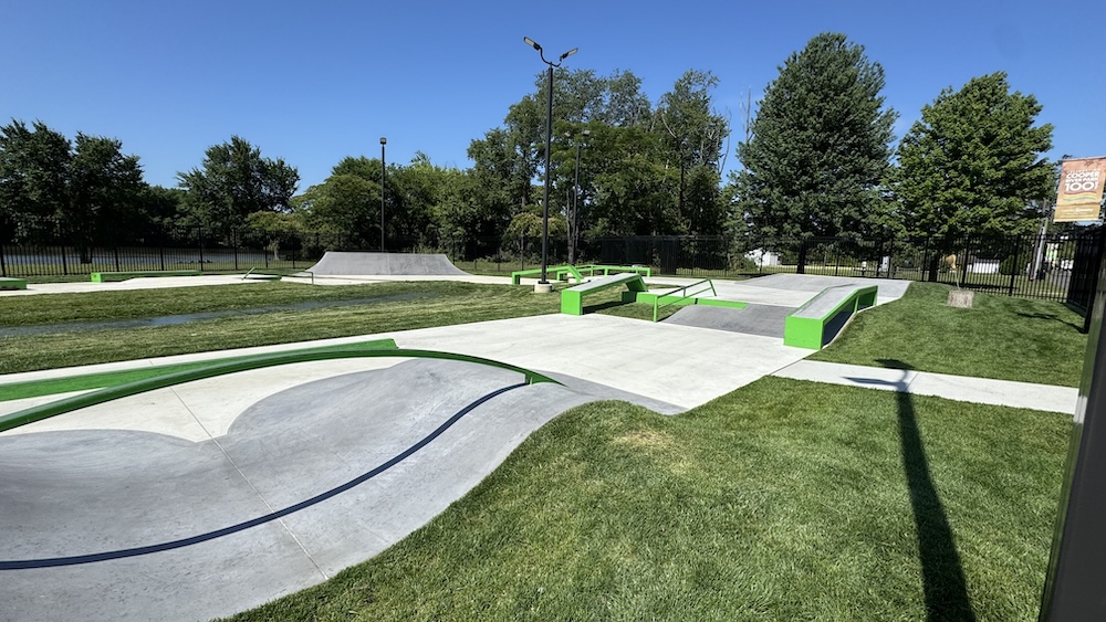 The new Cooper River Skatepark in Cherry Hill, NJ. View of the park with blue skies and trees.