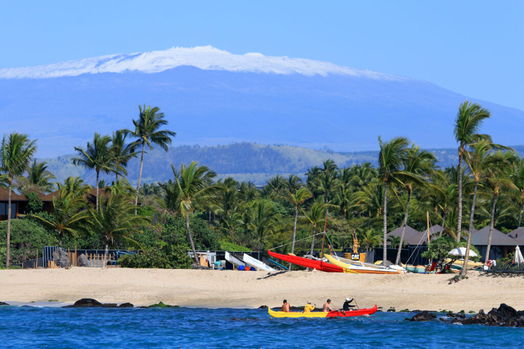 Snow-capped Mauna Kea volcano with the beach in the foreground on Hawaii's Big Island. 