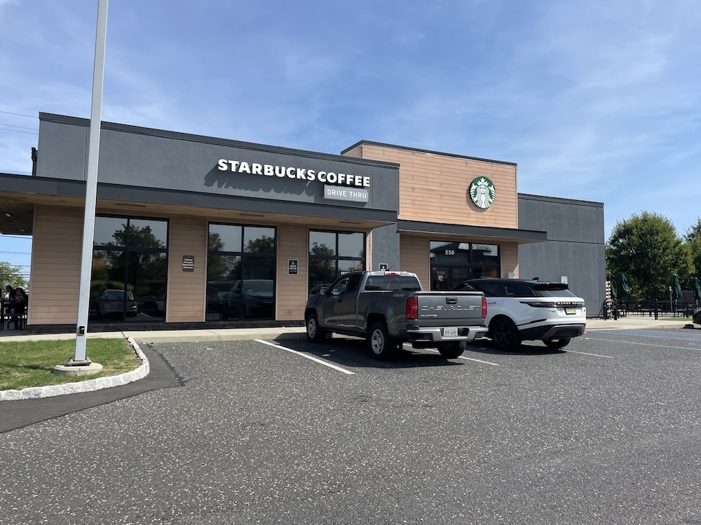 Exterior of Starbucks in Mount Laurel, NJ with blue skies behind it. 